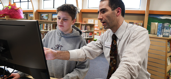 Man Pointing to Computer Terminal
