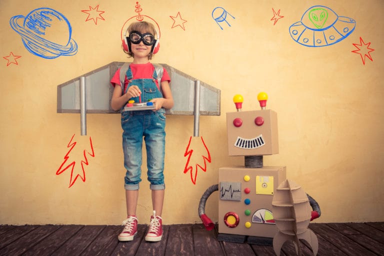 Kid Playing with Paper Robot and Rocket Equipment